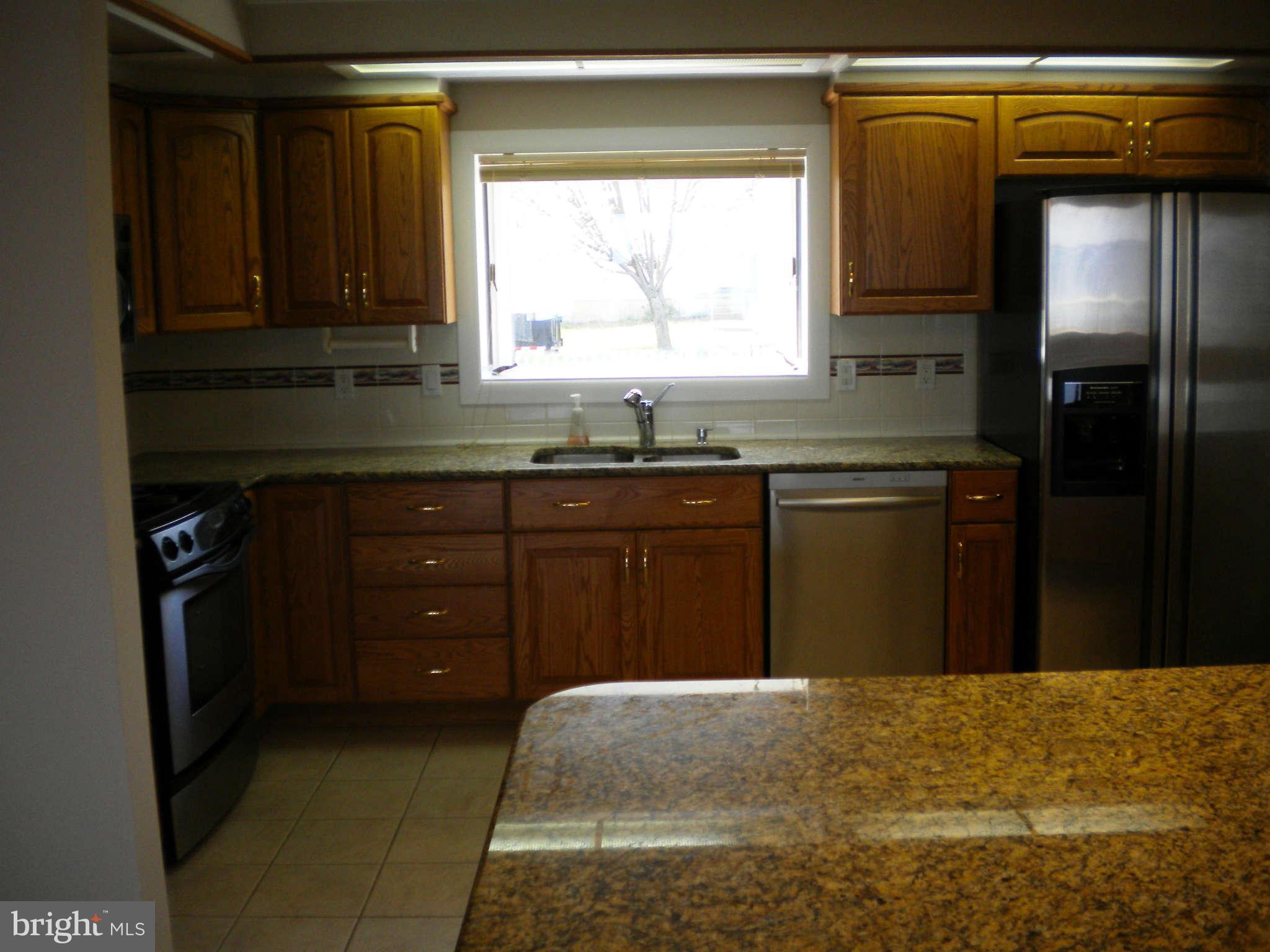 700 Long Point Road Grasonville, MD 21638 - Photo 3 of 20 a kitchen with a cabinets and a refrigerator