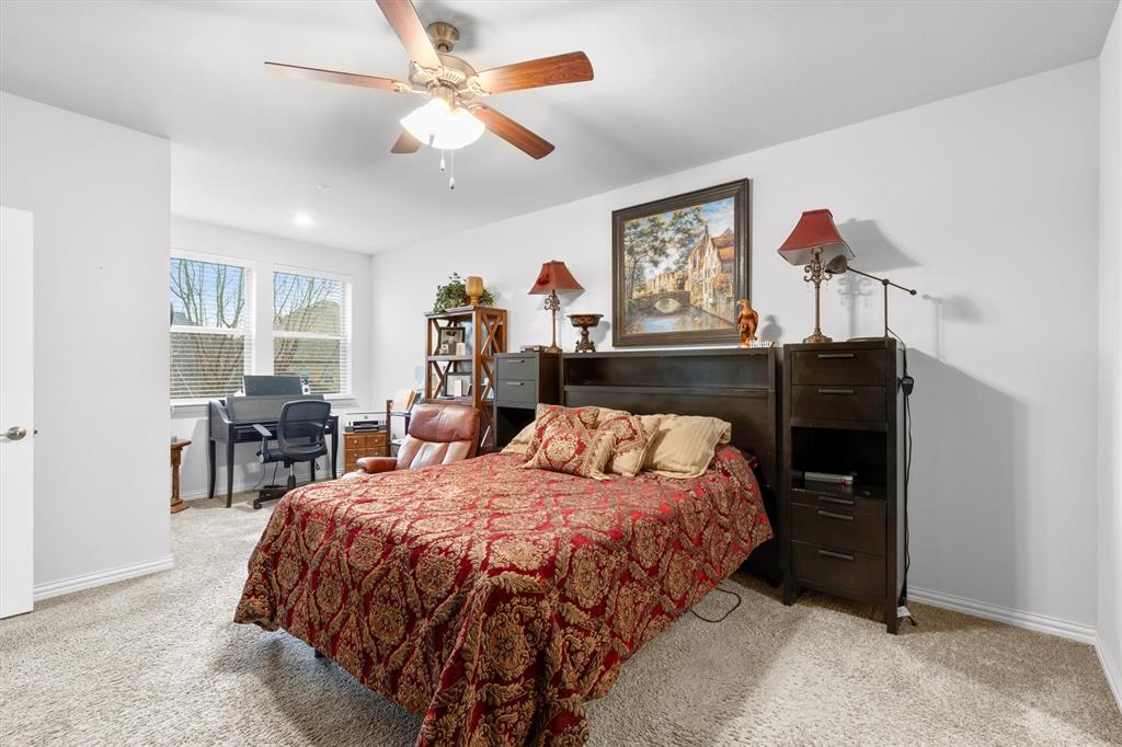 651 Watters Road, Unit 5205 Allen, TX 75013 - Photo 11 of 31 a bedroom with a bed a table and chair