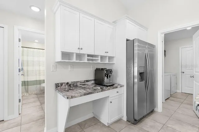 a kitchen with stainless steel appliances granite countertop a refrigerator and a stove top oven