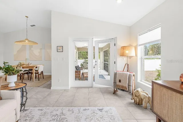 a living room with furniture and a dining table