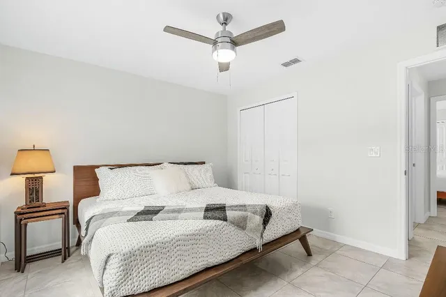 a bedroom with a bed and a lamp