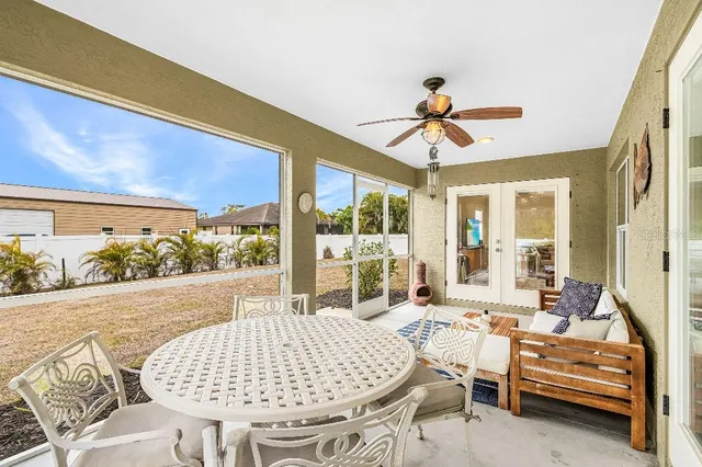 a living room with furniture and a floor to ceiling window