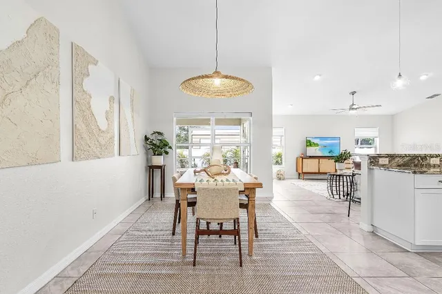 a dining room with wooden floor and a chandelier