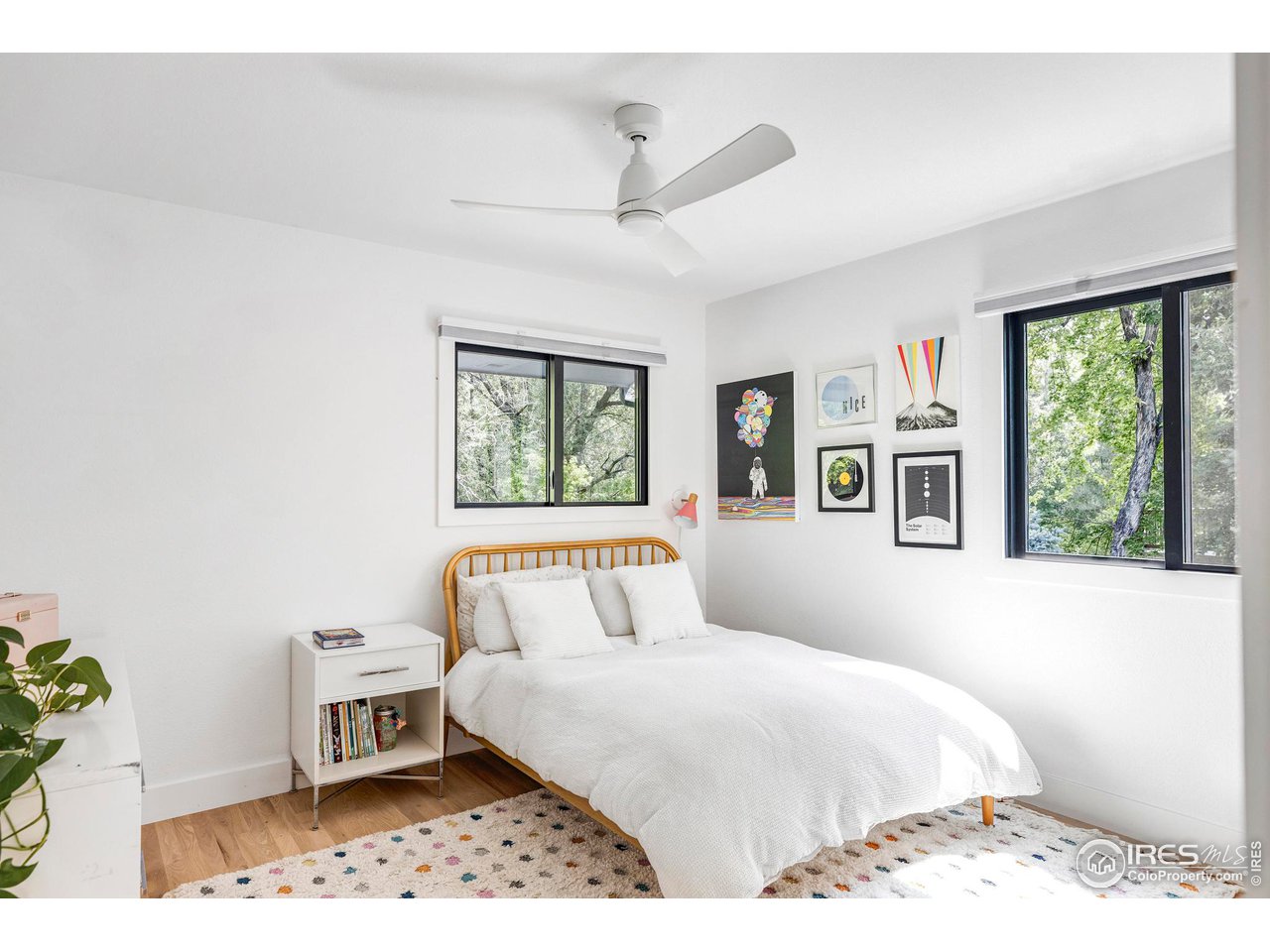 6095 Old Brompton Road Boulder, CO 80301 - Photo 21 of 34 a bedroom with a bed and a painting on the wall