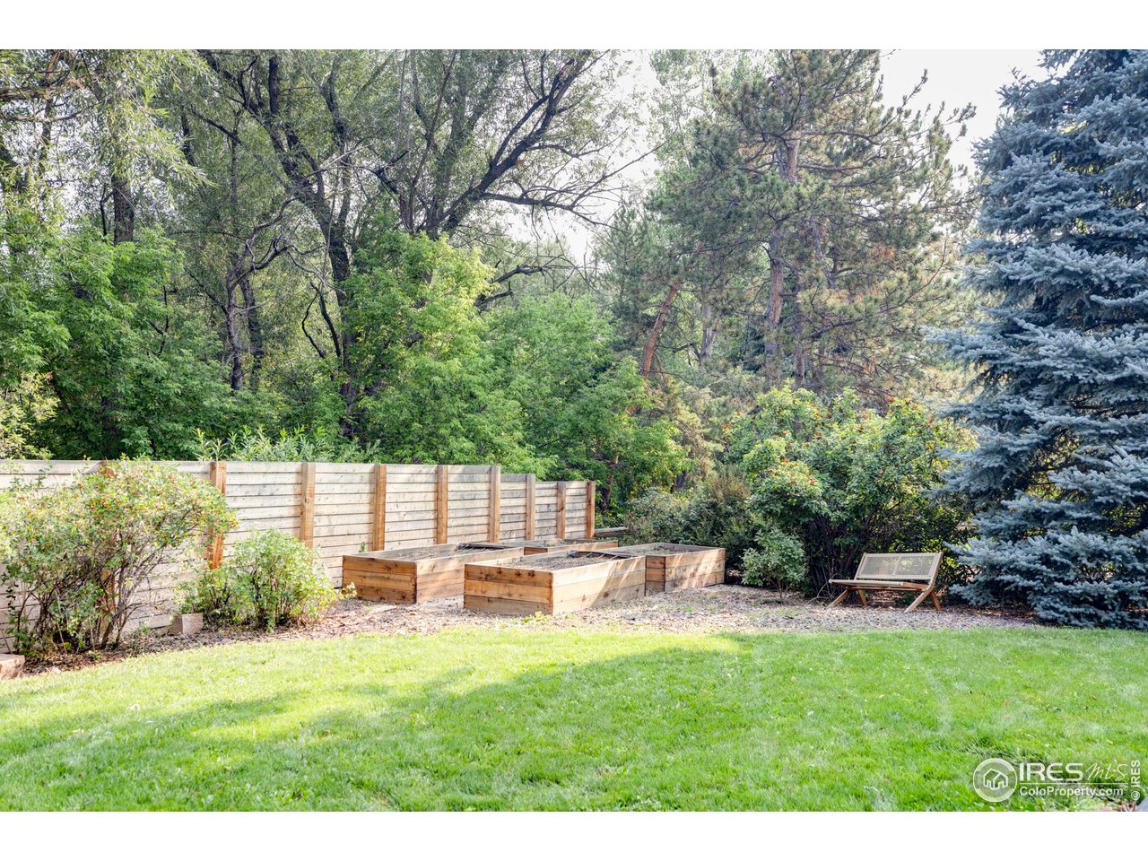 6095 Old Brompton Road Boulder, CO 80301 - Photo 29 of 34 a backyard of a house with yard and outdoor seating