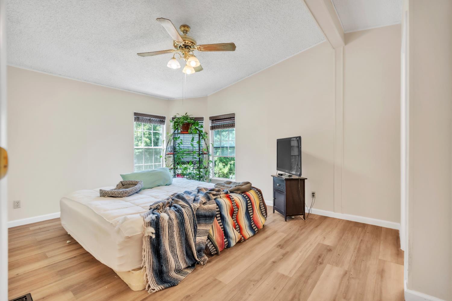 8074 Perry Creek Road, Unit 31 Somerset, CA 95684 - Photo 17 of 20 a bedroom with a bed and a chandelier