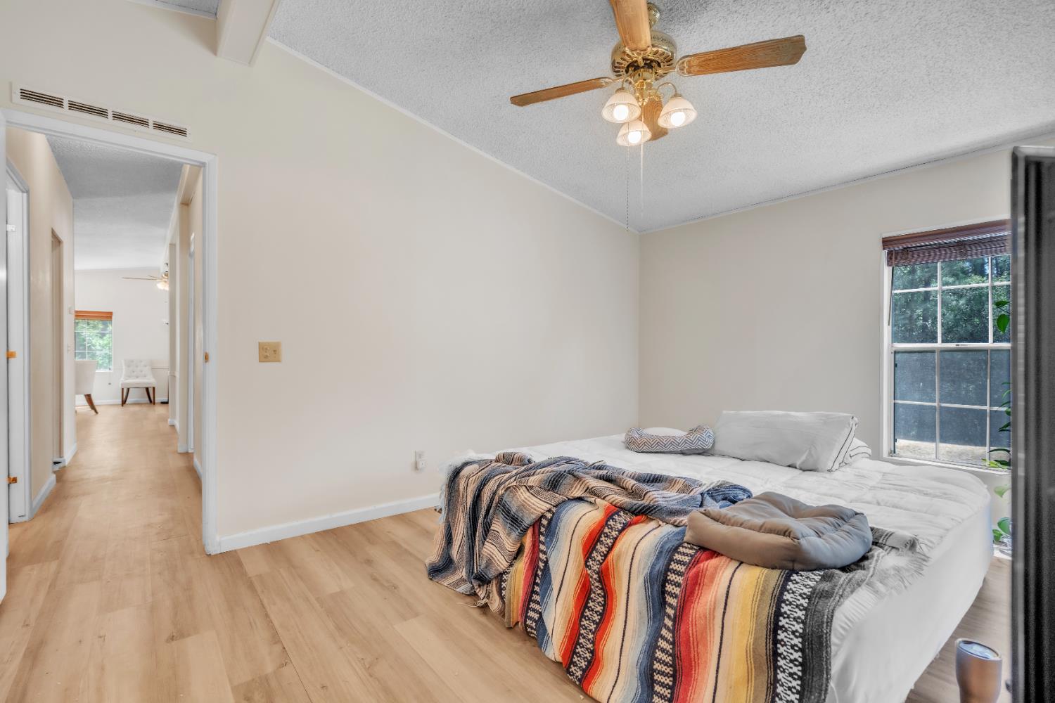 8074 Perry Creek Road, Unit 31 Somerset, CA 95684 - Photo 19 of 20 a bedroom with a bed and a chandelier