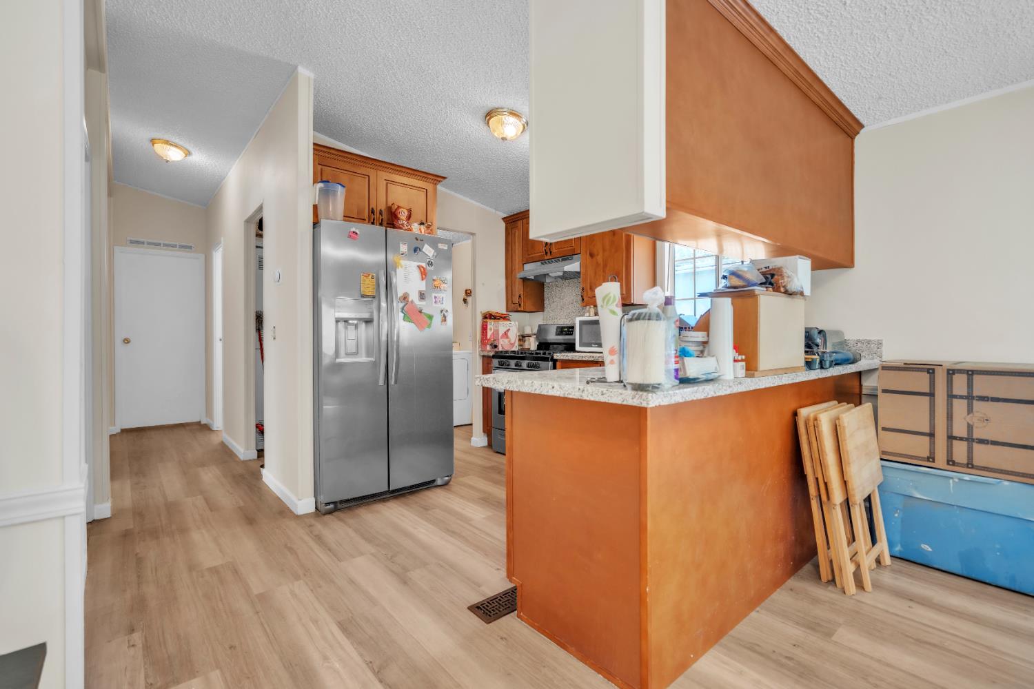8074 Perry Creek Road, Unit 31 Somerset, CA 95684 - Photo 10 of 20 a kitchen with stainless steel appliances granite countertop a refrigerator and a sink