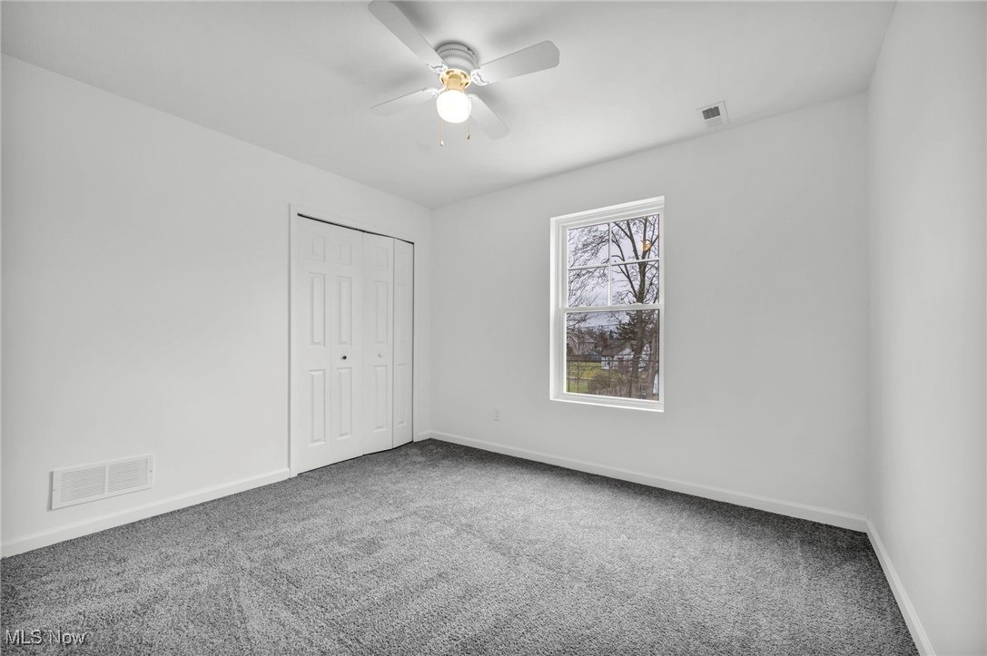 3734 Pennington Road Cleveland, OH 44120 - Photo 33 of 45 Unfurnished bedroom featuring carpet floors, a closet, and a ceiling fan