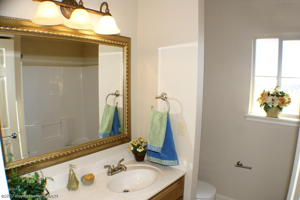 5304 Pleasant Court Amarillo, TX 79110 - Photo 11 of 13 a bathroom with a sink and a mirror