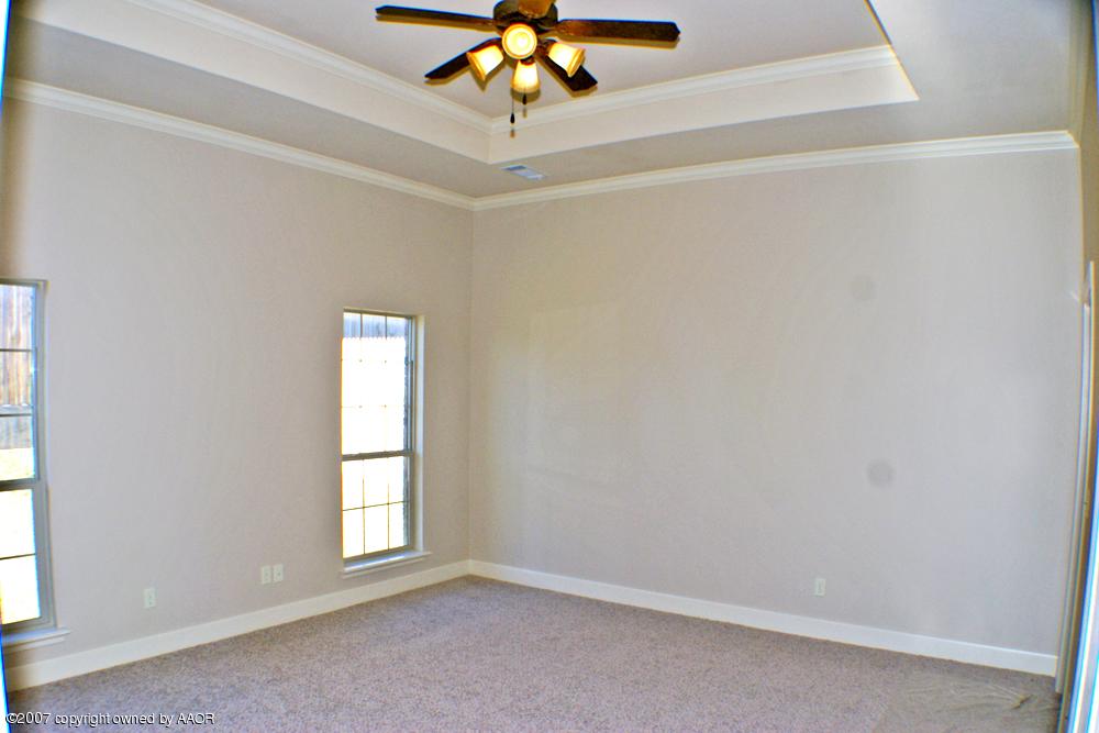 5304 Pleasant Court Amarillo, TX 79110 - Photo 6 of 13 an empty room with windows and chandelier fan