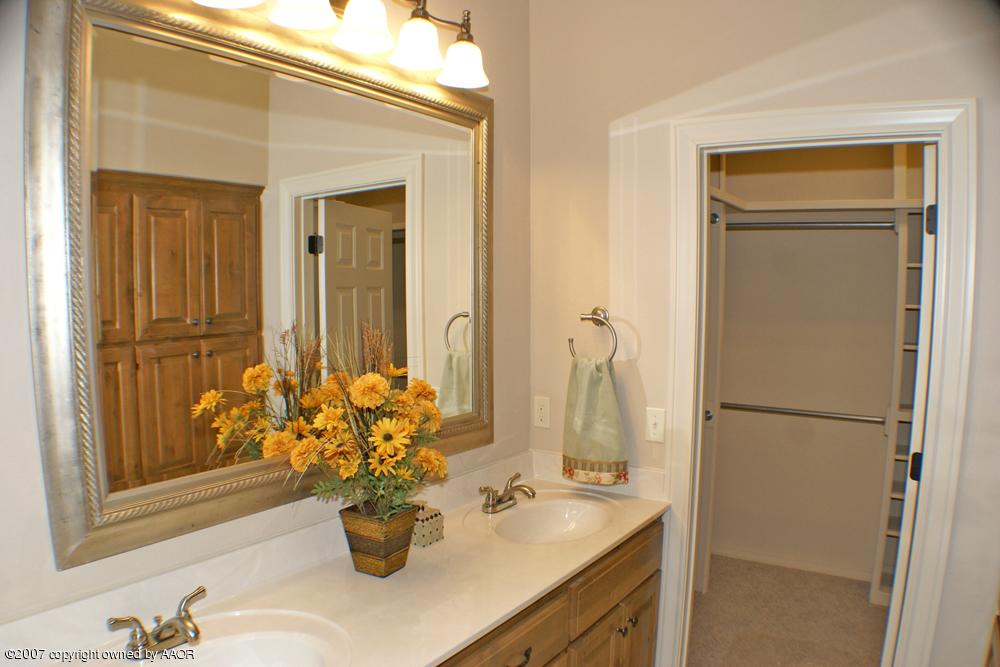 5304 Pleasant Court Amarillo, TX 79110 - Photo 7 of 13 a bathroom with a sink a vanity and a mirror