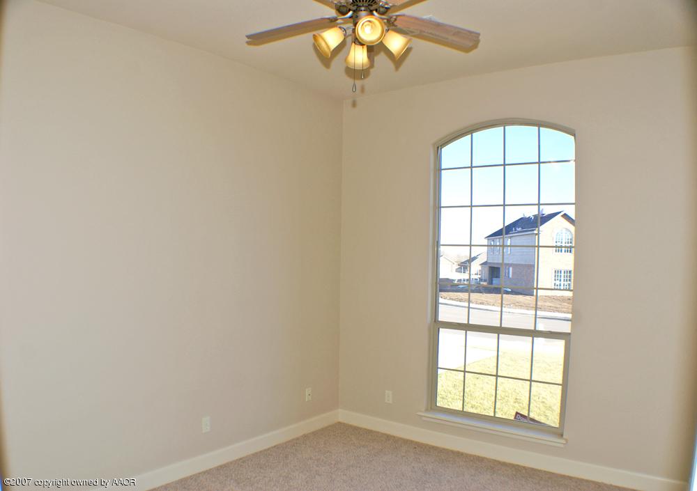 5304 Pleasant Court Amarillo, TX 79110 - Photo 10 of 13 an empty room with windows and chandelier