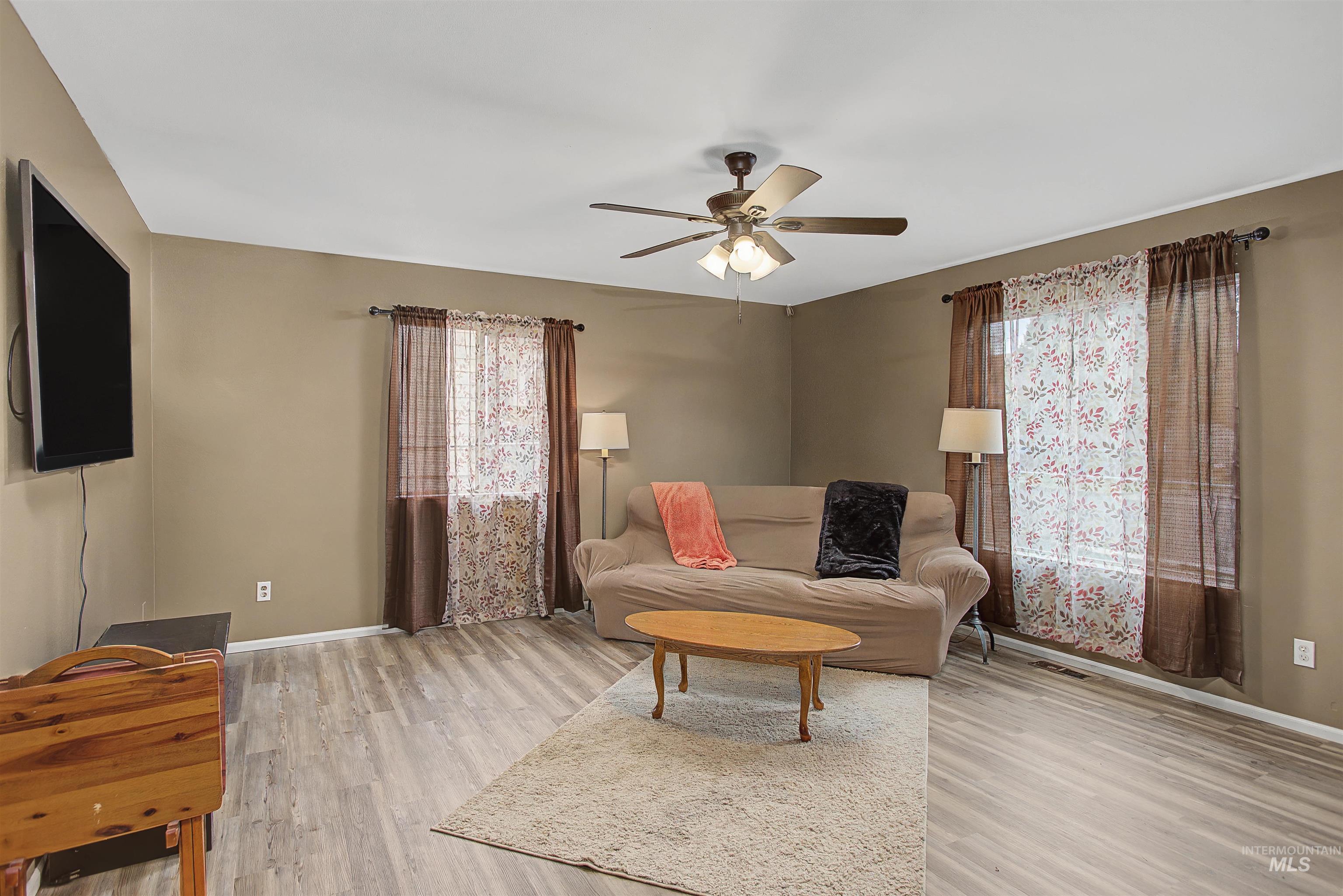 919 9th Street Clarkston, WA 99403 - Photo 16 of 34 Living area featuring light wood-style flooring and a ceiling fan