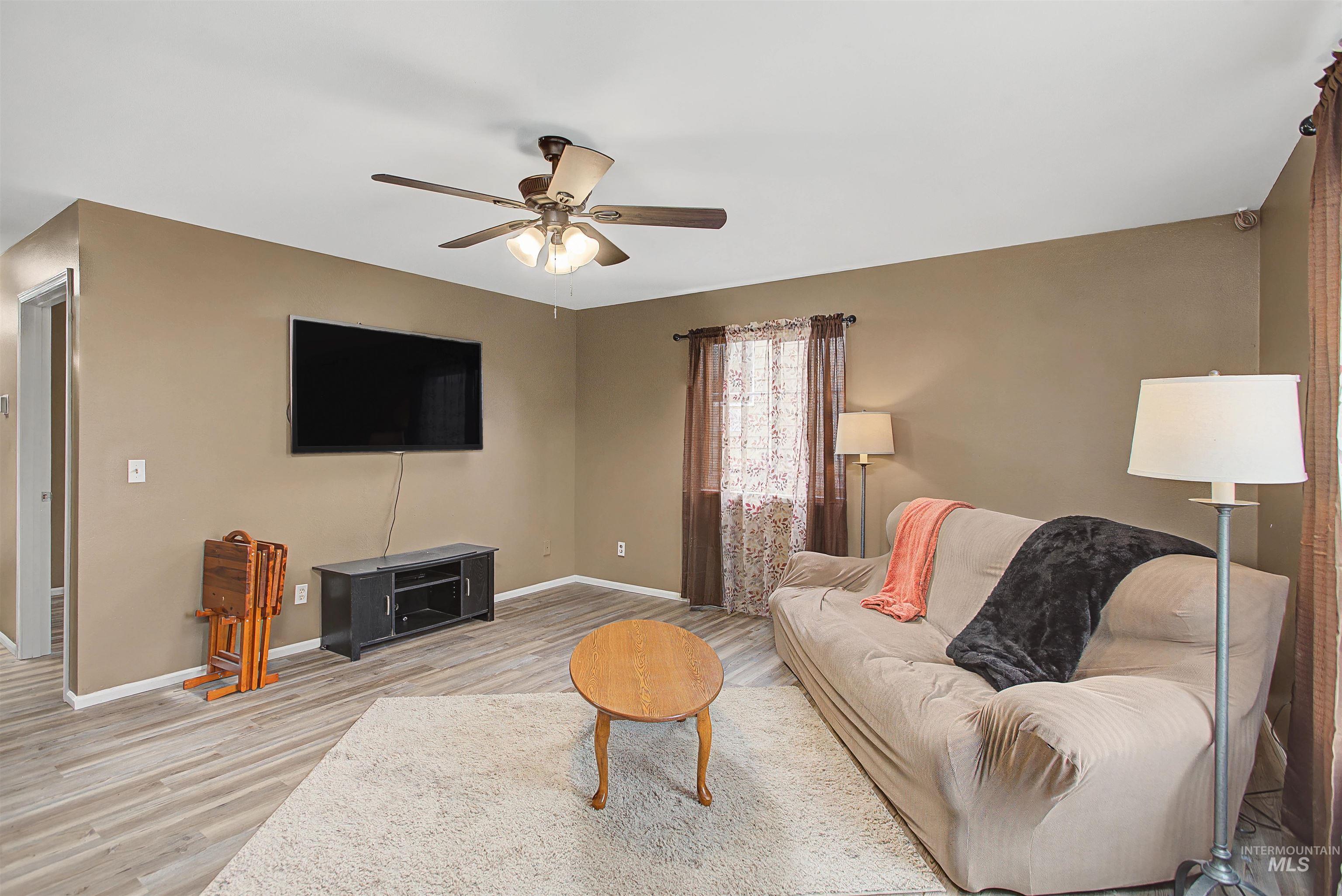 919 9th Street Clarkston, WA 99403 - Photo 17 of 34 Living room featuring a ceiling fan and light wood-style floors