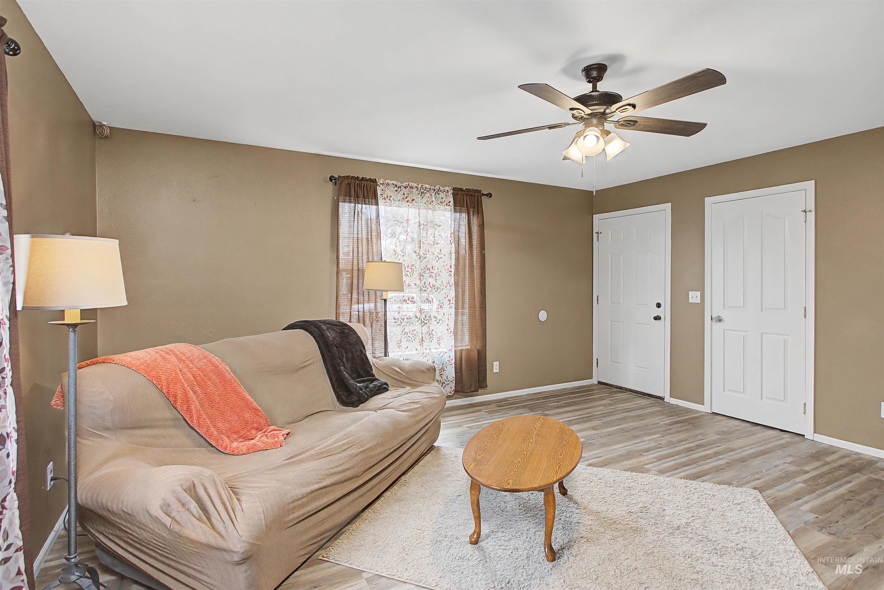 919 9th Street Clarkston, WA 99403 - Photo 18 of 34 Living room featuring wood finished floors and ceiling fan