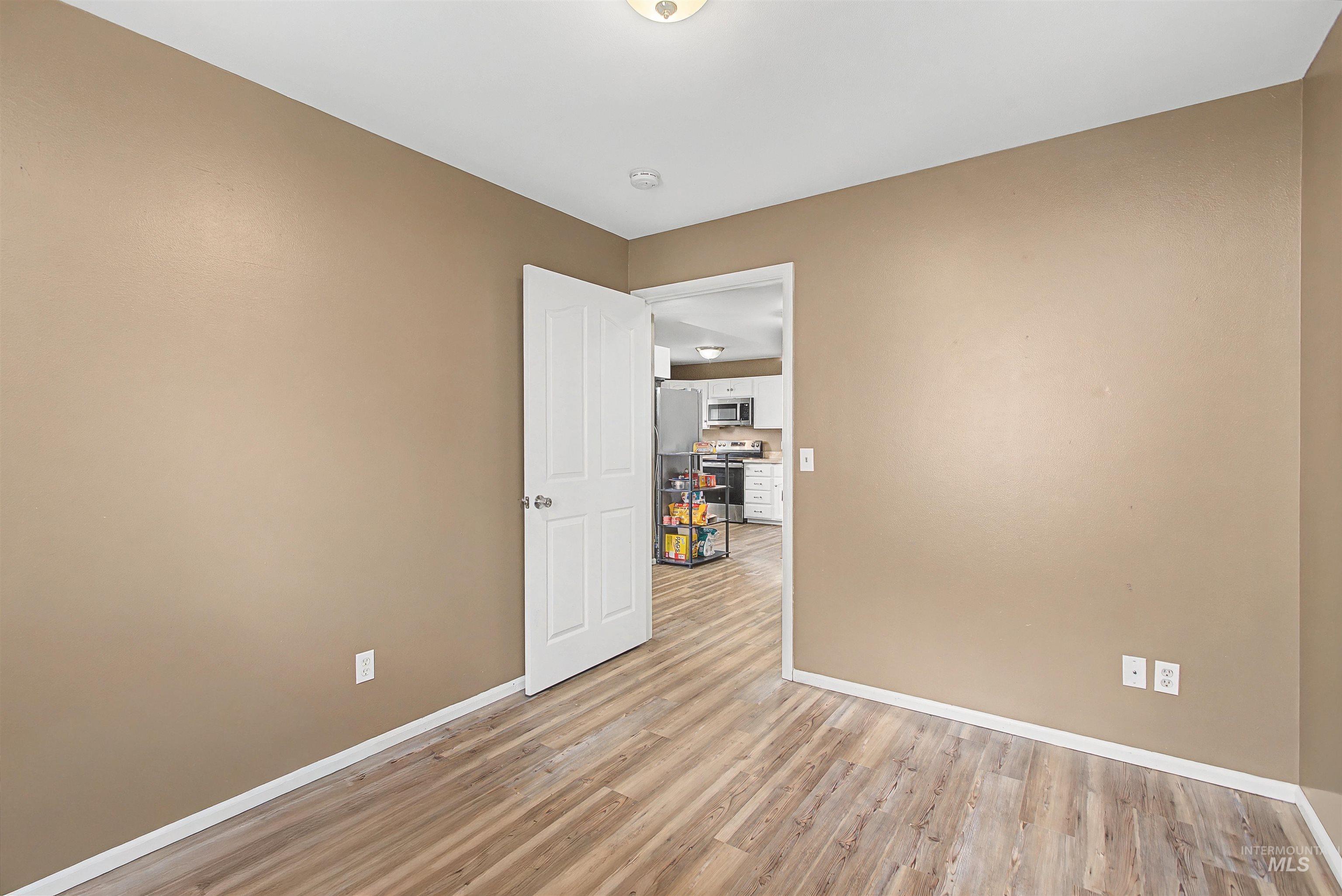 919 9th Street Clarkston, WA 99403 - Photo 20 of 34 Unfurnished room featuring light wood-style floors and baseboards