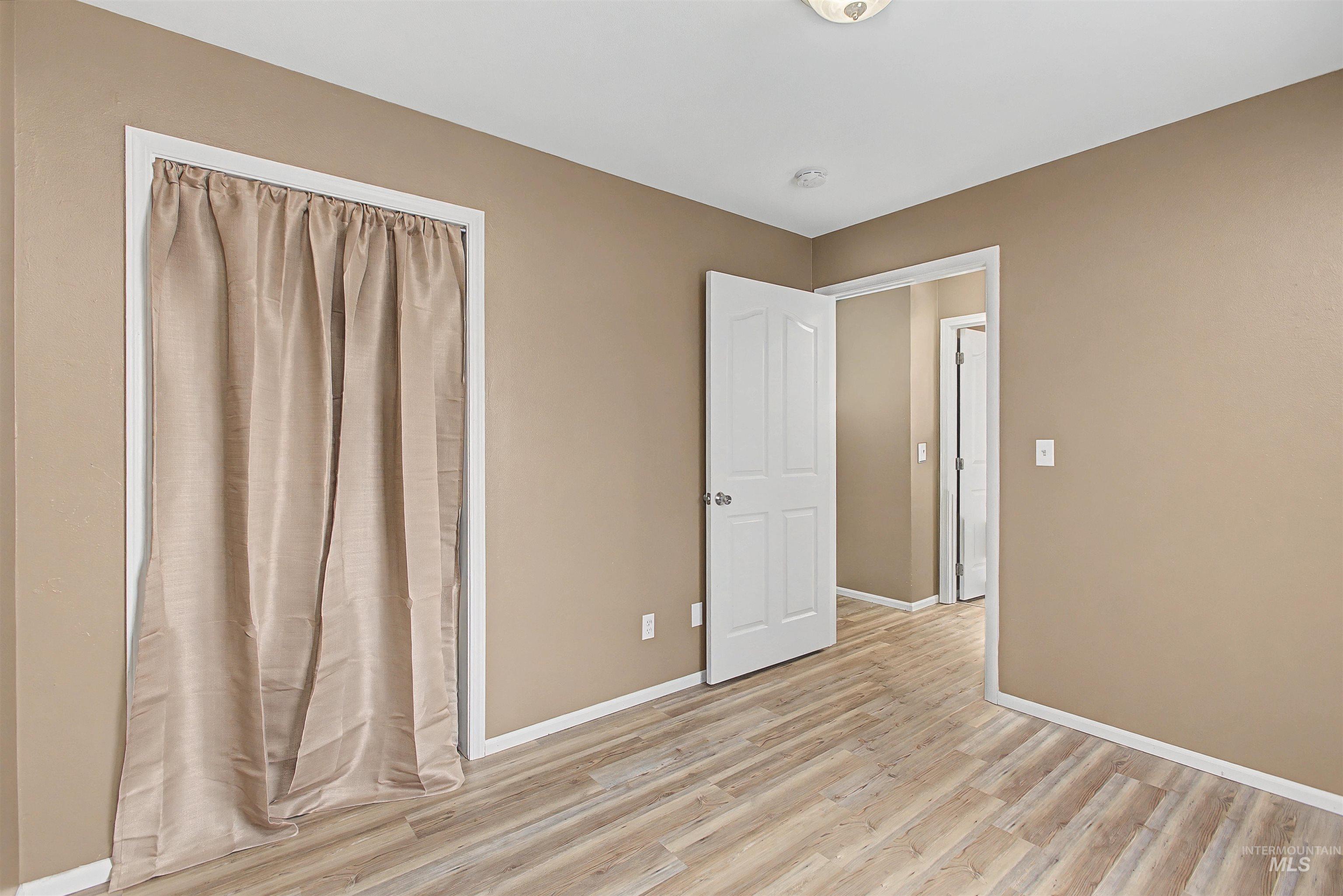 919 9th Street Clarkston, WA 99403 - Photo 22 of 34 Unfurnished bedroom featuring light wood-style floors and baseboards