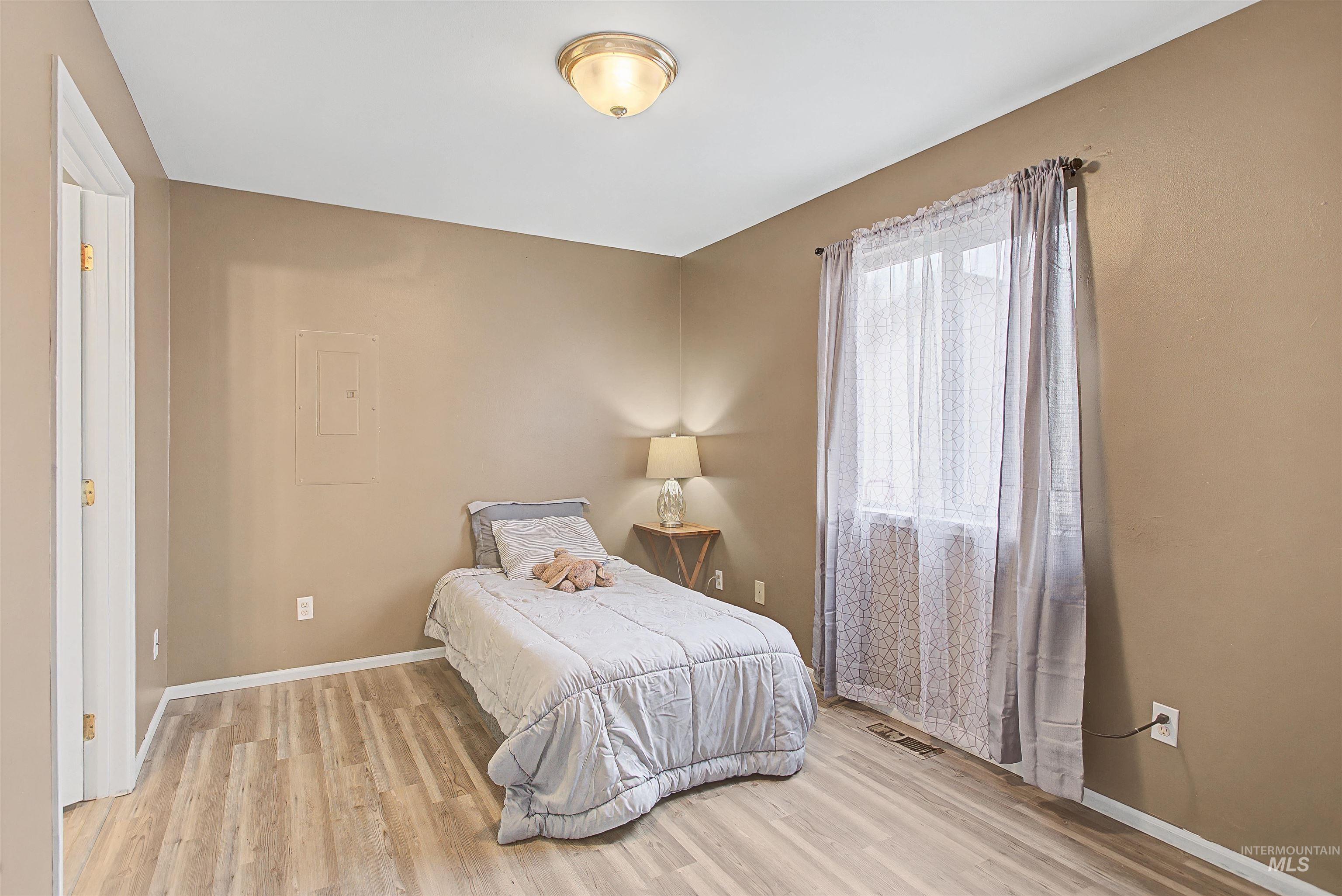 919 9th Street Clarkston, WA 99403 - Photo 23 of 34 Bedroom featuring light wood finished floors and electric panel
