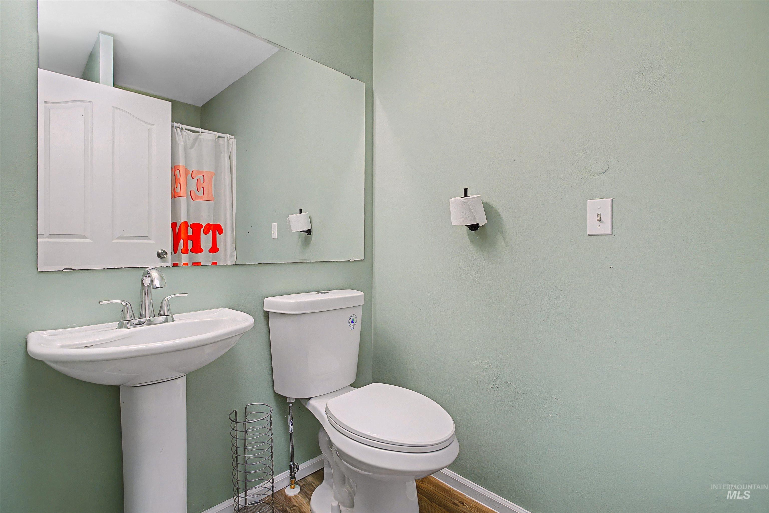 919 9th Street Clarkston, WA 99403 - Photo 5 of 34 Bathroom with a shower with curtain and wood finished floors
