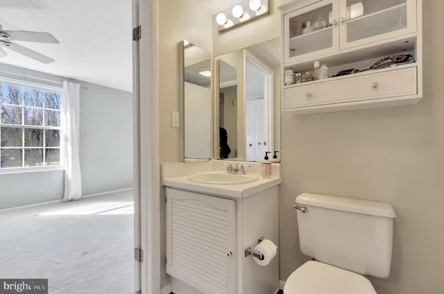 an empty room with closet and a chandelier fan