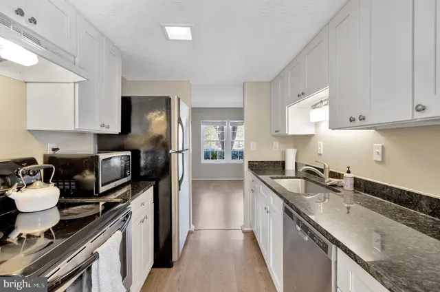a kitchen with a sink stove and refrigerator