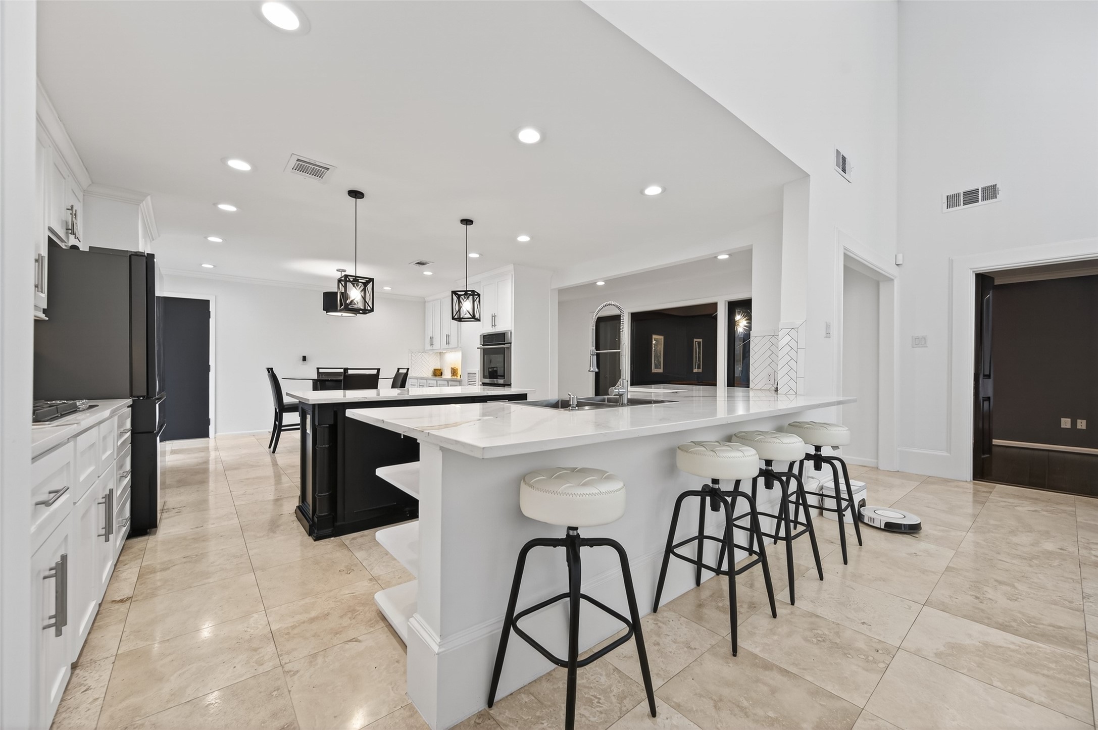 6226 Pebble Beach Drive Houston, TX 77069 - Photo 6 of 46 a kitchen with stainless steel appliances kitchen island granite countertop a refrigerator a stove a sink a dining table and chairs