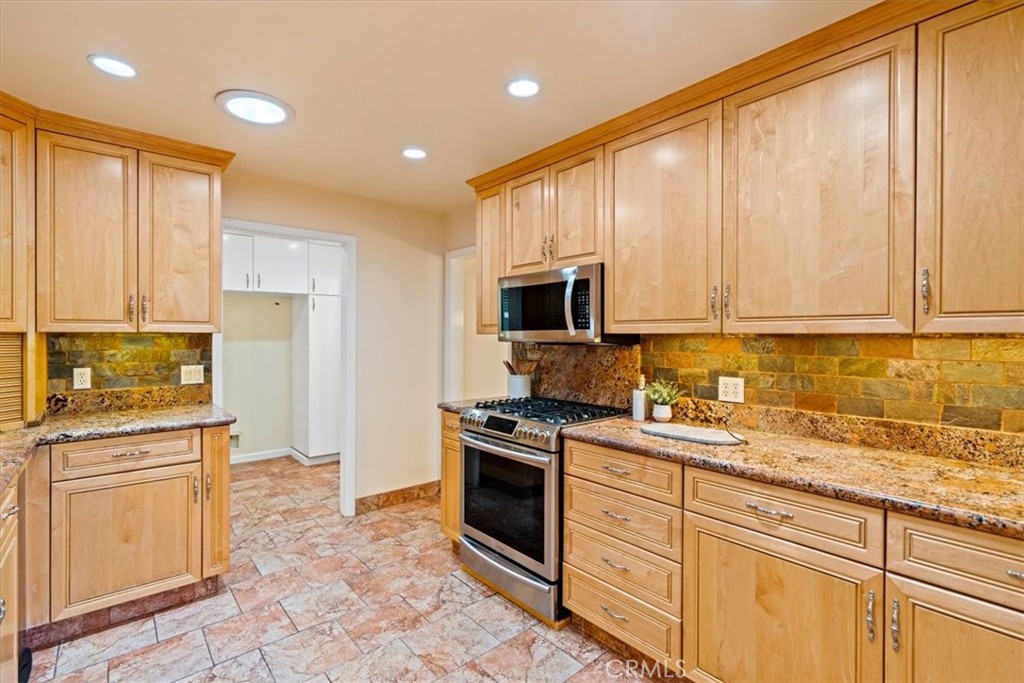 318 Indio Drive Pismo Beach, CA 93449 - Photo 13 of 58 a kitchen with stainless steel appliances granite countertop a stove a sink and a microwave