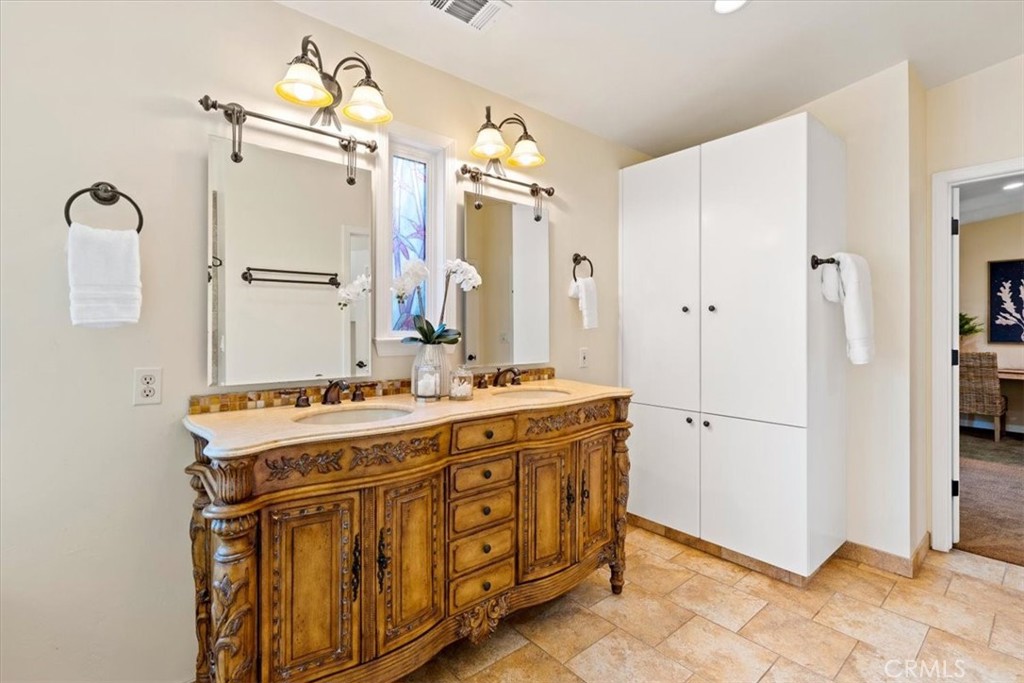 318 Indio Drive Pismo Beach, CA 93449 - Photo 21 of 58 a spacious bathroom with a sink mirror and a shower