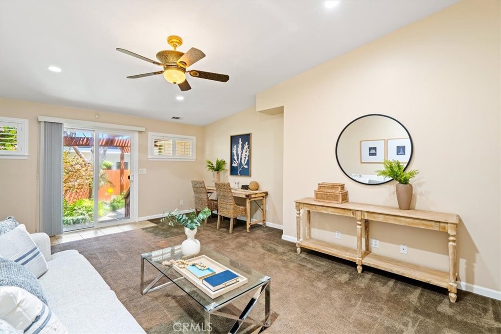 318 Indio Drive Pismo Beach, CA 93449 - Photo 23 of 58 a living room with furniture a window and a chandelier