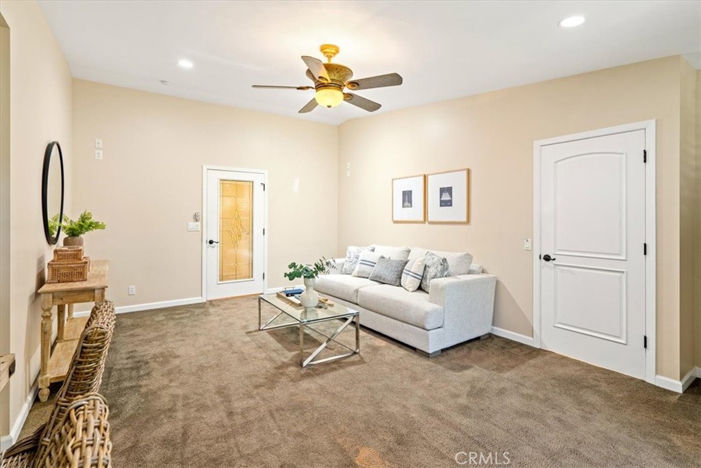 318 Indio Drive Pismo Beach, CA 93449 - Photo 25 of 58 a living room with furniture and a chandelier