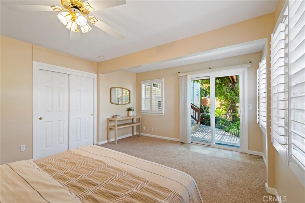318 Indio Drive Pismo Beach, CA 93449 - Photo 28 of 58 a bedroom with a bed and a chandelier