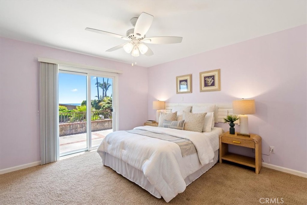 318 Indio Drive Pismo Beach, CA 93449 - Photo 31 of 58 a bedroom with a bed and a chandelier