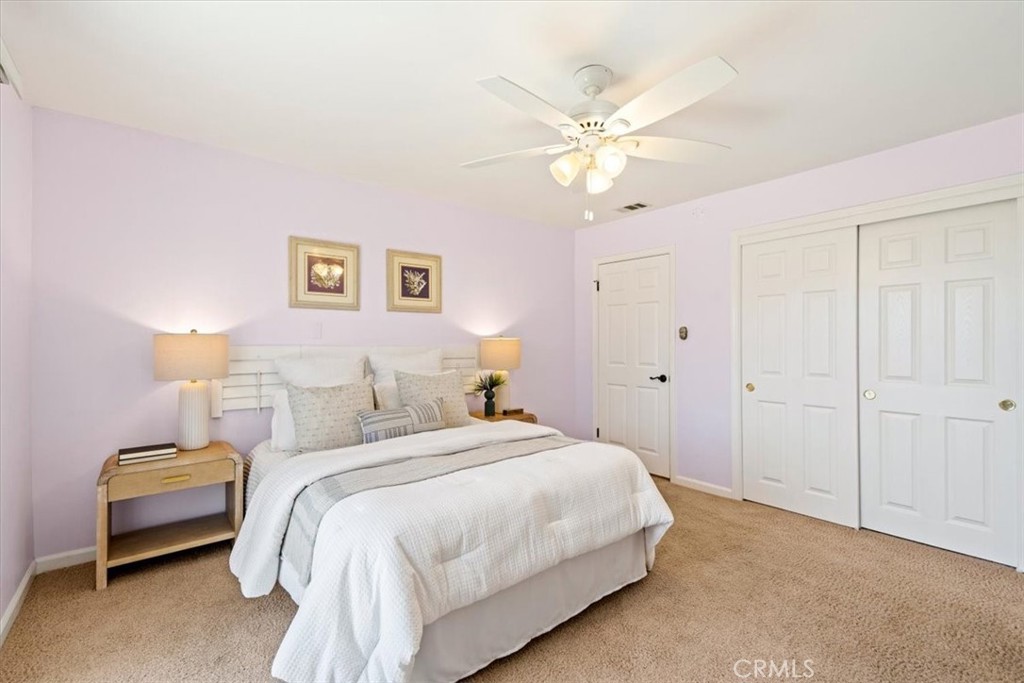 318 Indio Drive Pismo Beach, CA 93449 - Photo 32 of 58 a bedroom with a bed and a chandelier