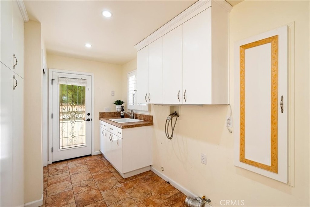 318 Indio Drive Pismo Beach, CA 93449 - Photo 34 of 58 a kitchen with a sink and a refrigerator