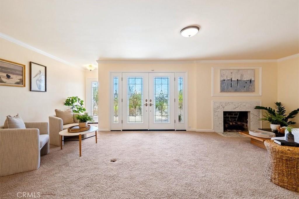 318 Indio Drive Pismo Beach, CA 93449 - Photo 7 of 58 a living room with furniture a fireplace and a potted plant