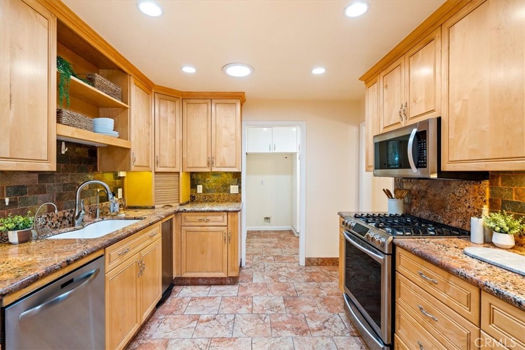 318 Indio Drive Pismo Beach, CA 93449 - Photo 10 of 58 a kitchen with stainless steel appliances granite countertop a stove top oven a sink dishwasher a refrigerator and cabinets with wooden floor