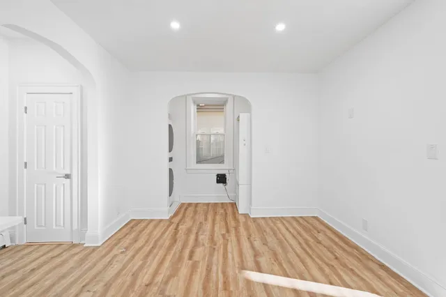 a view of a room with wooden floor