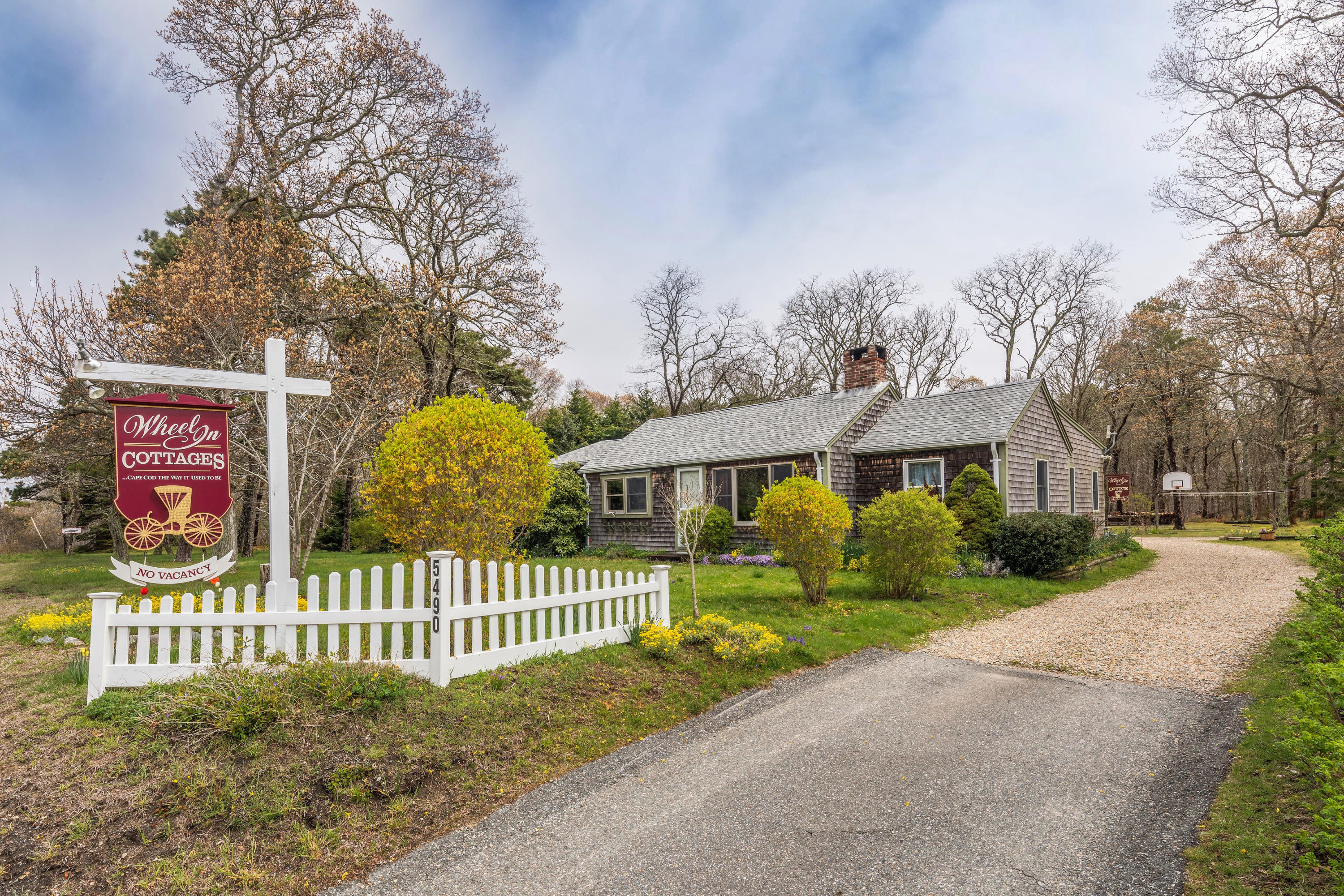 5490 State Highway Eastham, MA 02642 - Photo 1 of 28 a view of a white house with a large trees plants and large trees