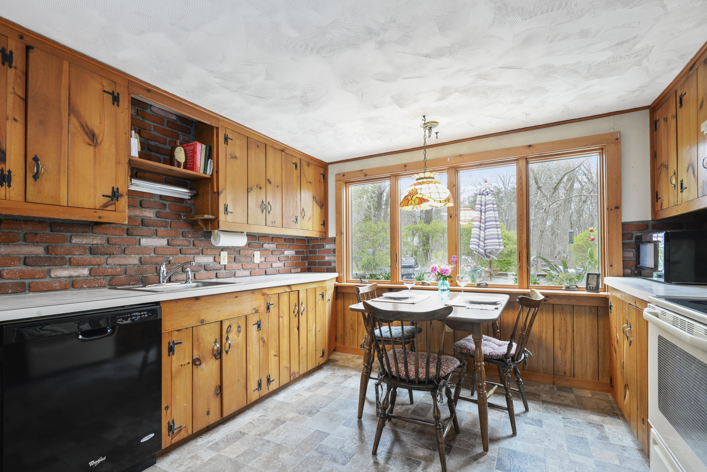 5490 State Highway Eastham, MA 02642 - Photo 8 of 28 a open kitchen with stainless steel appliances granite countertop a stove top oven a sink dishwasher and cabinets with wooden floor
