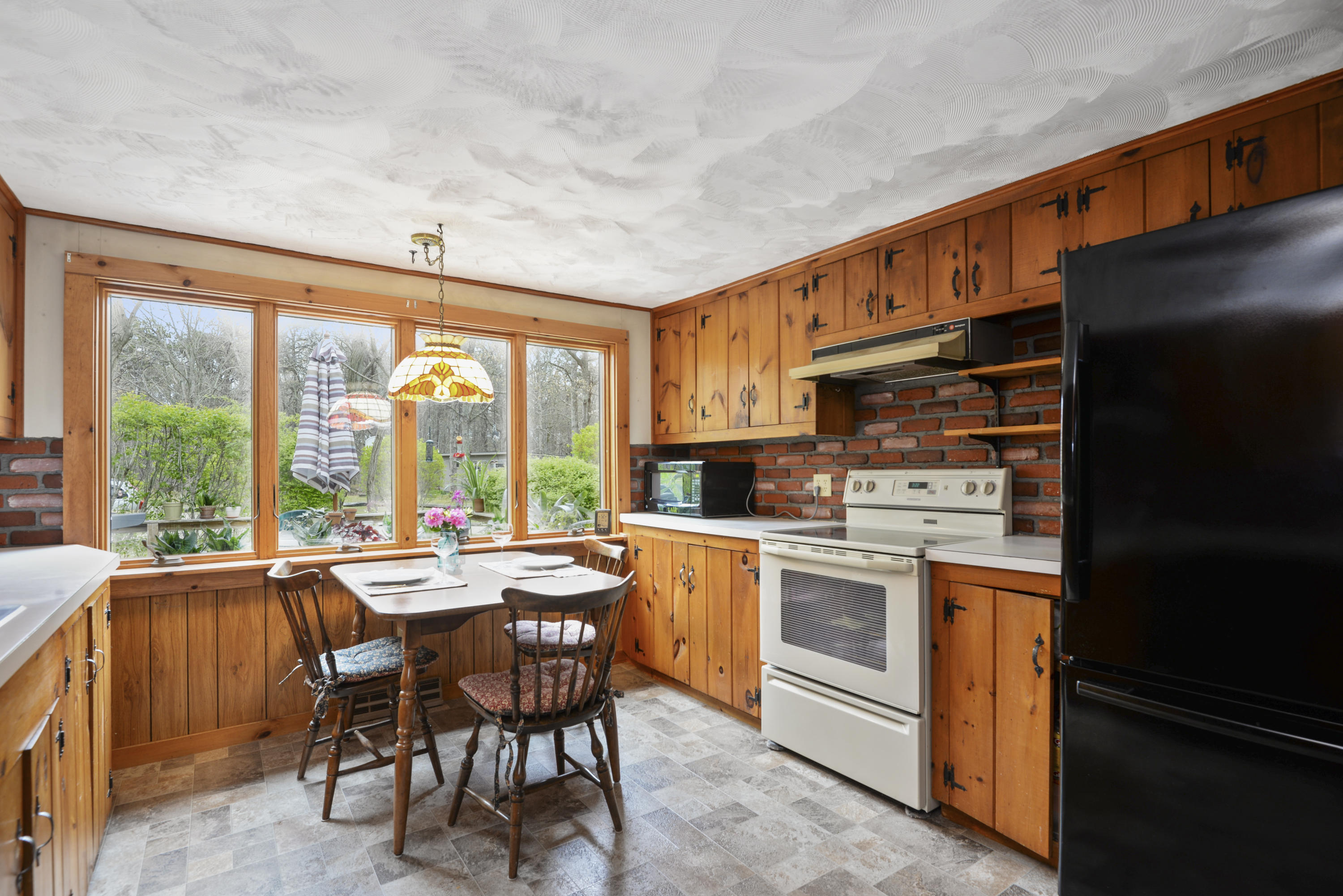 5490 State Highway Eastham, MA 02642 - Photo 9 of 28 a kitchen with stainless steel appliances granite countertop a stove and a refrigerator