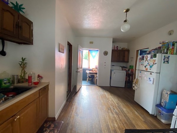 220 Vernon Street Worcester, MA 01607 - Photo 11 of 29 a kitchen with refrigerator a sink and wooden floor