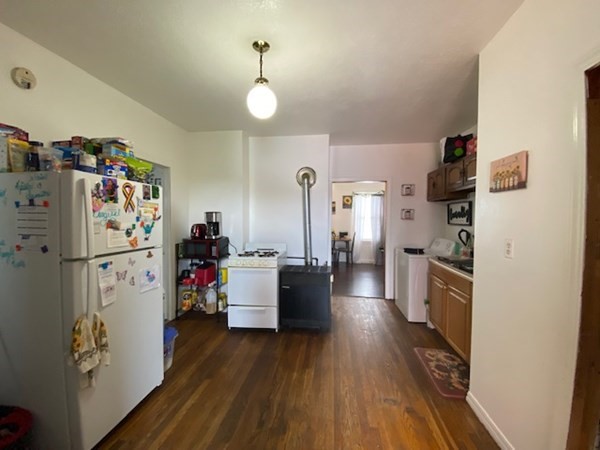 220 Vernon Street Worcester, MA 01607 - Photo 15 of 29 a kitchen with a refrigerator a stove and wooden floor