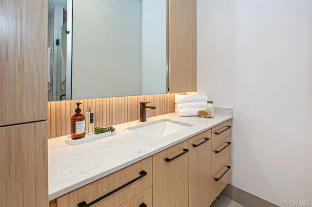 a bathroom with a sink and a mirror