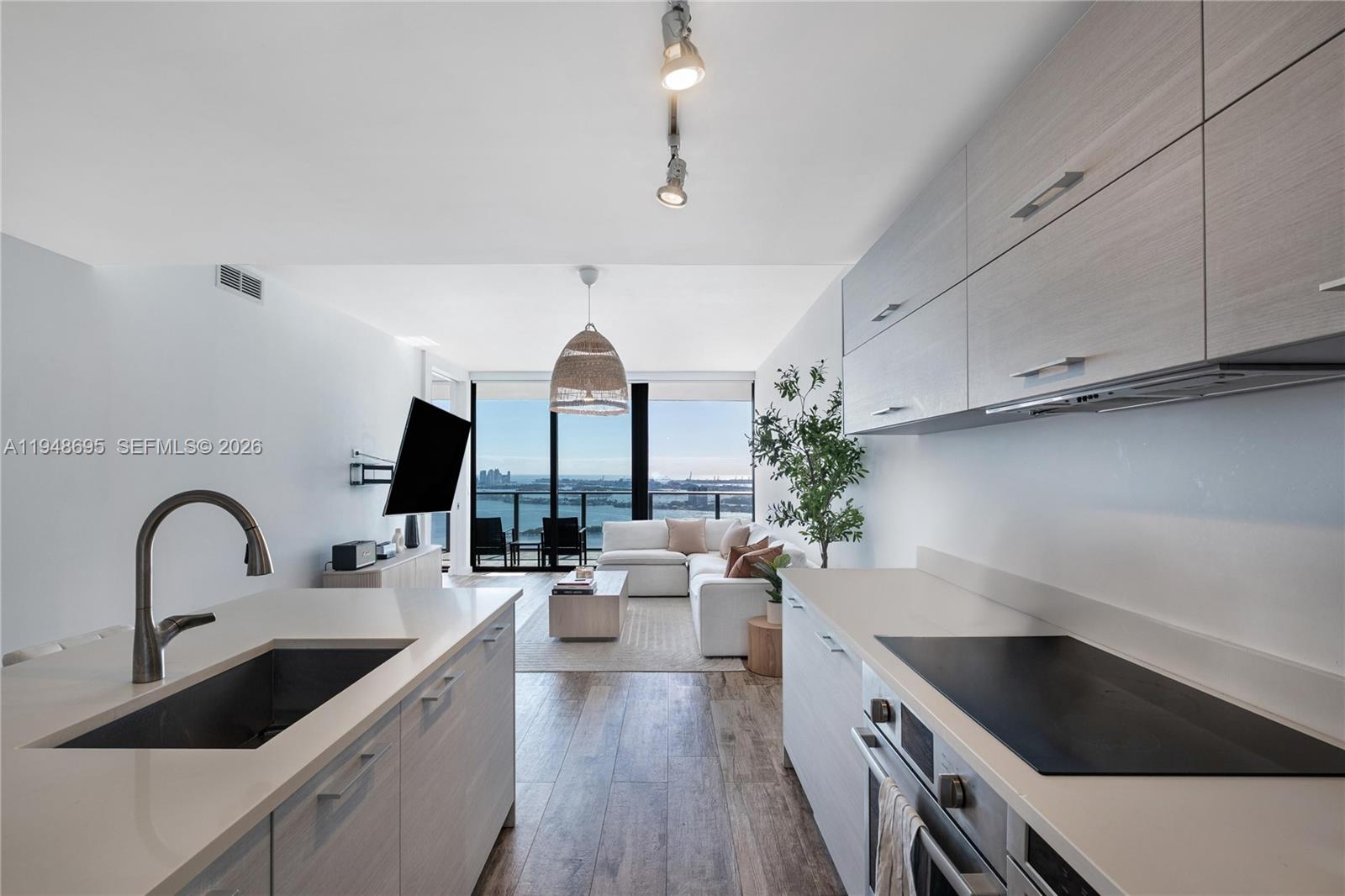 650 Northeast 32nd Street, Unit 4306 Miami, FL 33137 - Photo 13 of 52 a kitchen with sink a refrigerator and cabinets