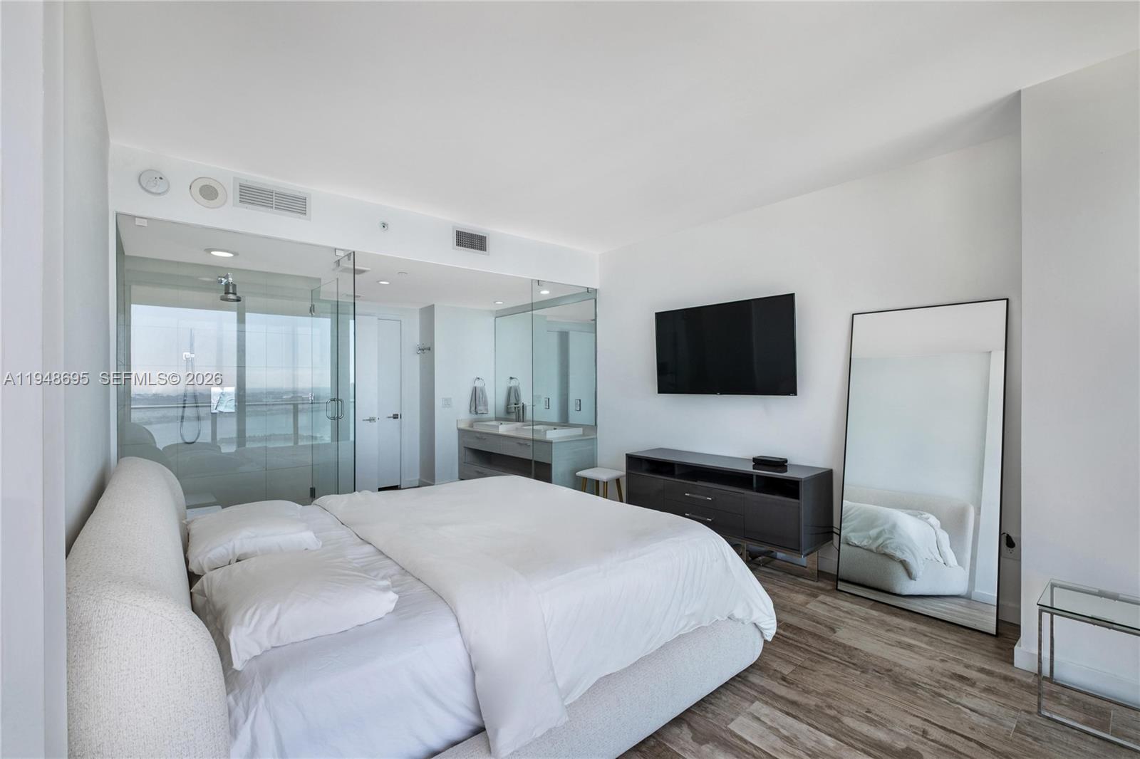 650 Northeast 32nd Street, Unit 4306 Miami, FL 33137 - Photo 17 of 52 a bedroom with a bed and a flat screen tv