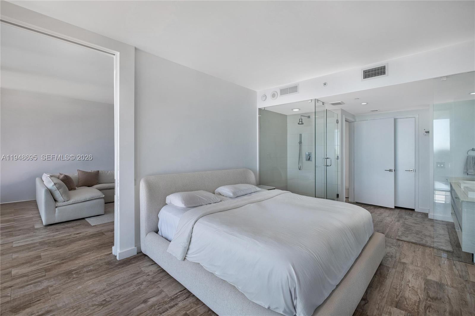 650 Northeast 32nd Street, Unit 4306 Miami, FL 33137 - Photo 18 of 52 a spacious bedroom with a bed and a couch