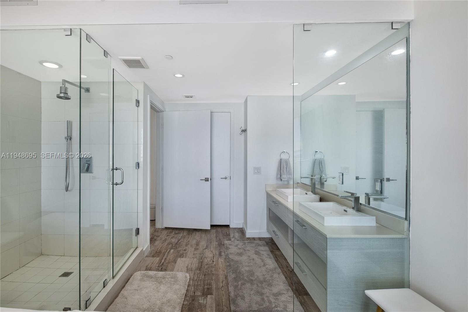 650 Northeast 32nd Street, Unit 4306 Miami, FL 33137 - Photo 20 of 52 a bathroom with a double vanity sink a toilet and shower