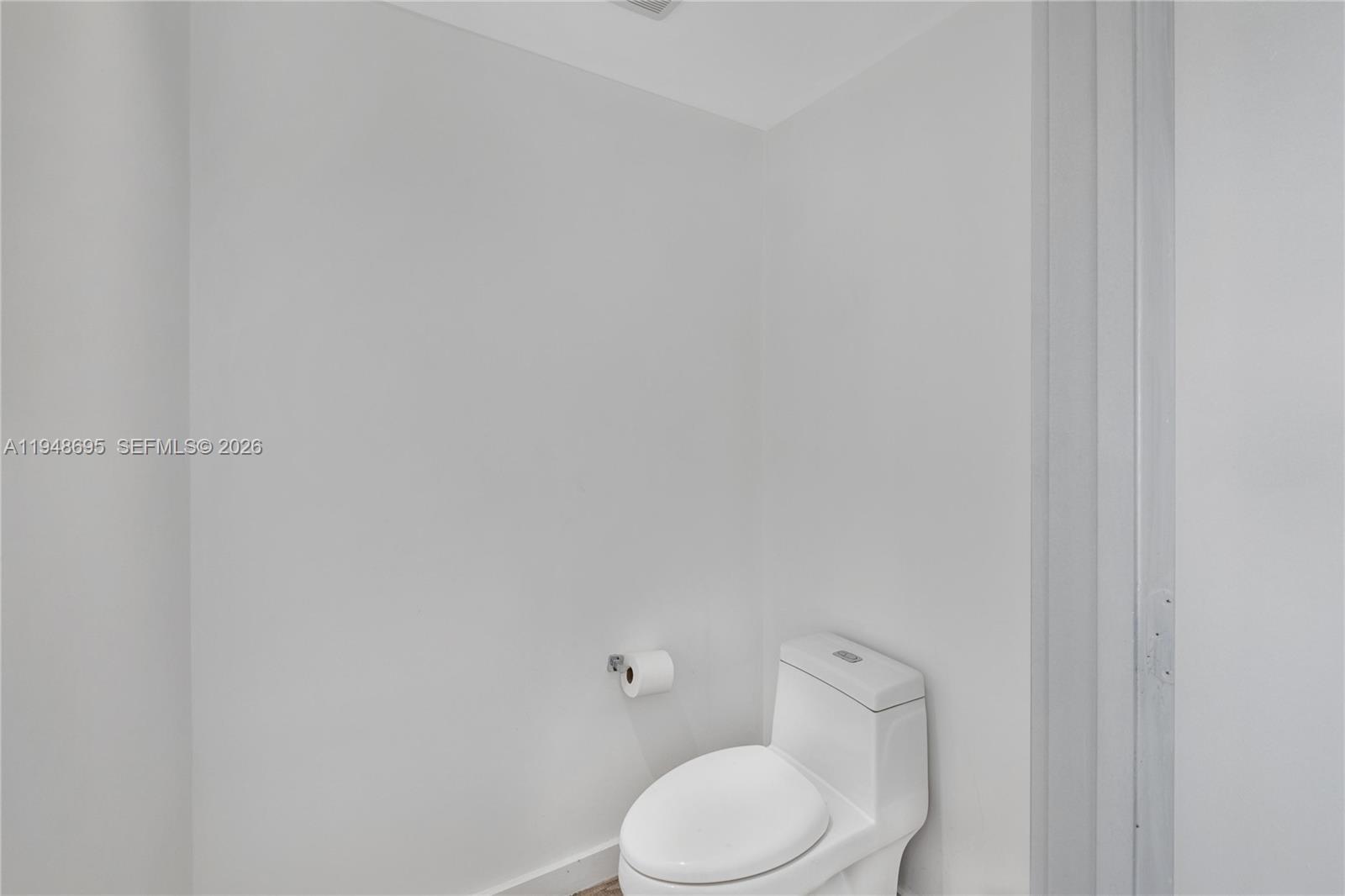 650 Northeast 32nd Street, Unit 4306 Miami, FL 33137 - Photo 22 of 52 a white toilet sitting next to a white wall