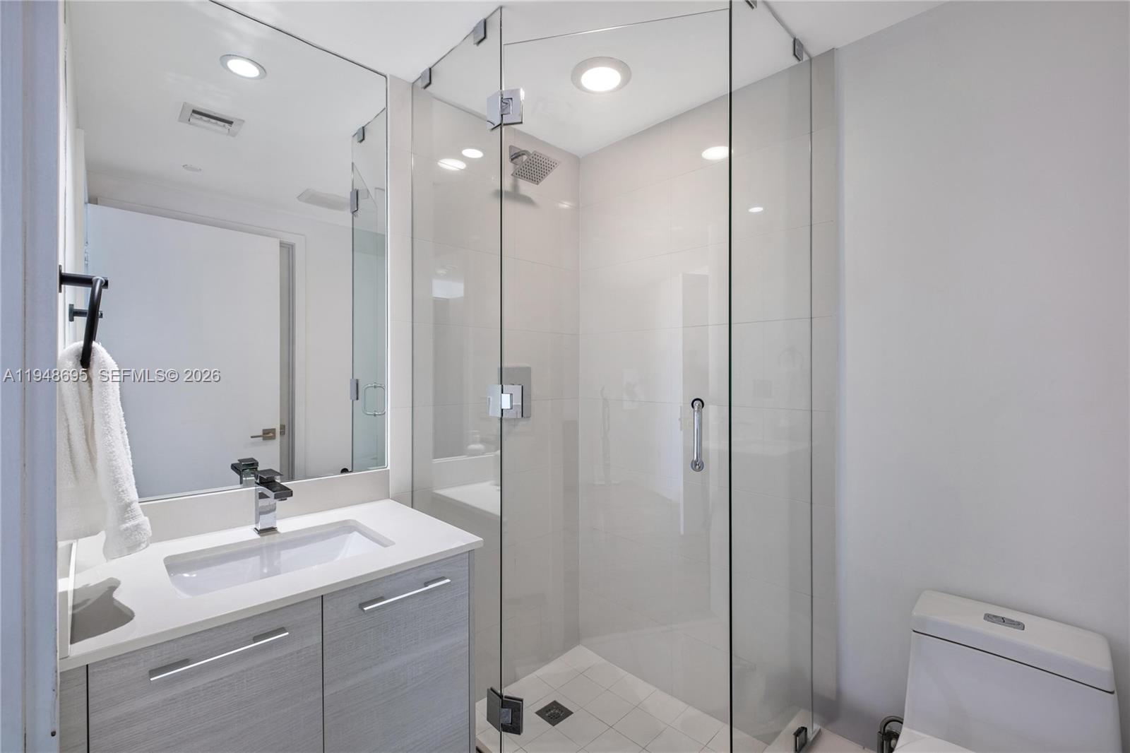 650 Northeast 32nd Street, Unit 4306 Miami, FL 33137 - Photo 25 of 52 a bathroom with a sink a toilet and shower